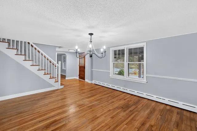 a view of entryway with wooden floor and window