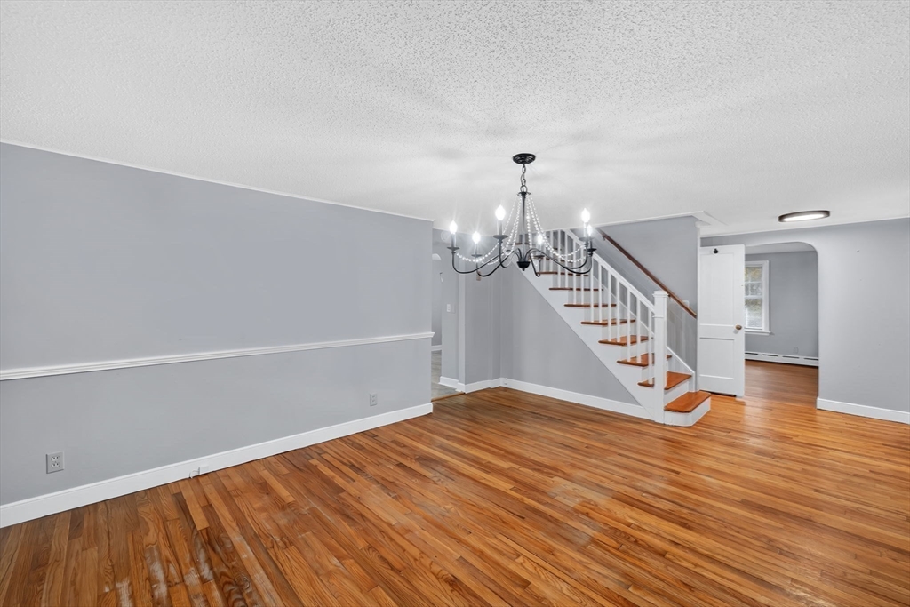 4 Leonard Road Stafford, CT 06076 - Photo 13 of 37 a view of an empty room with wooden floor and stairs