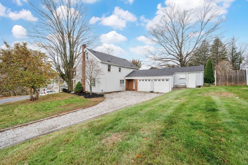 4 Leonard Road Stafford, CT 06076 - Photo 4 of 37 a view of a white house with a big yard and large trees
