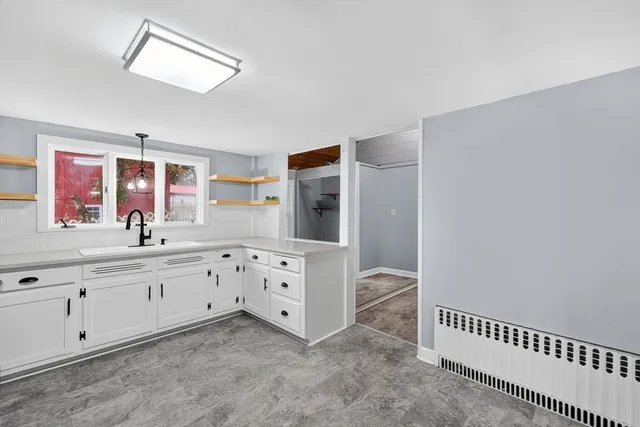 an empty room with cabinet and wooden floor