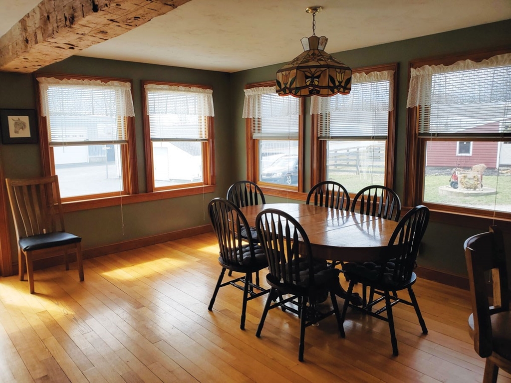 64 Arch Street Westborough, MA 01581 - Photo 12 of 42 a dining room with furniture a chandelier and wooden floor