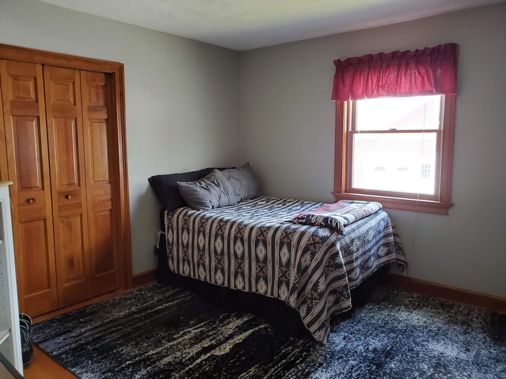 64 Arch Street Westborough, MA 01581 - Photo 21 of 42 a bed sitting in a bedroom next to a window