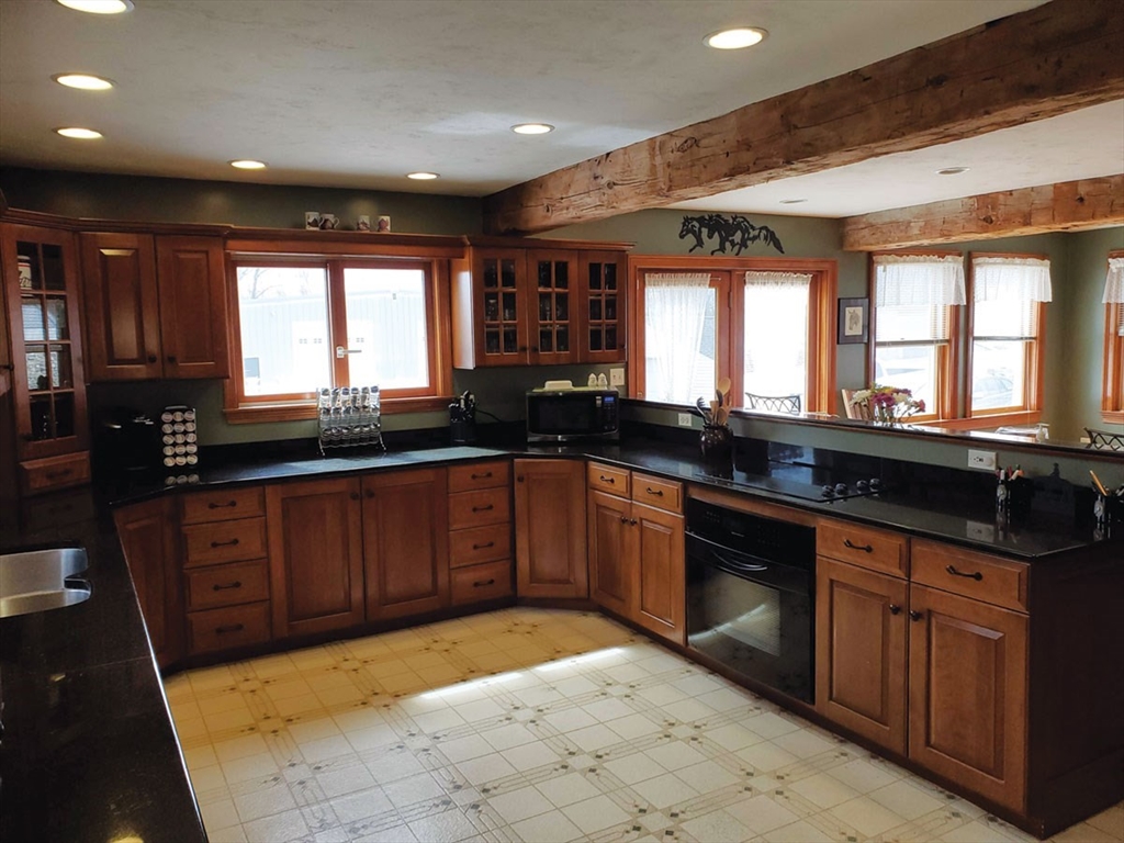 64 Arch Street Westborough, MA 01581 - Photo 9 of 42 a large kitchen with granite countertop a sink and a stove