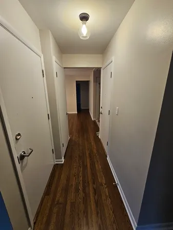 a view of a hallway and wooden floor