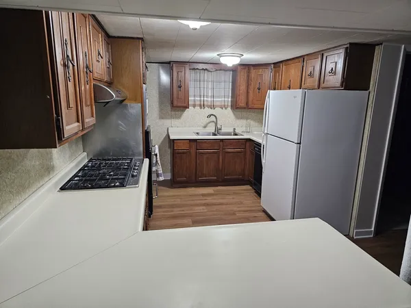 a kitchen with refrigerator and window