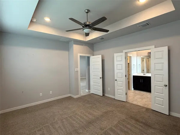 an empty room with closet and windows