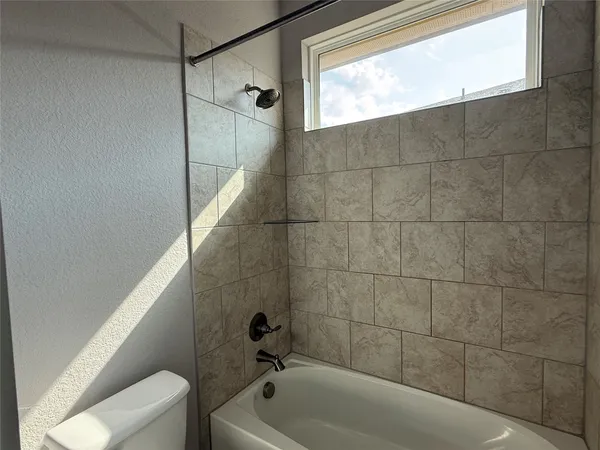 a bathroom with a shower and bathtub