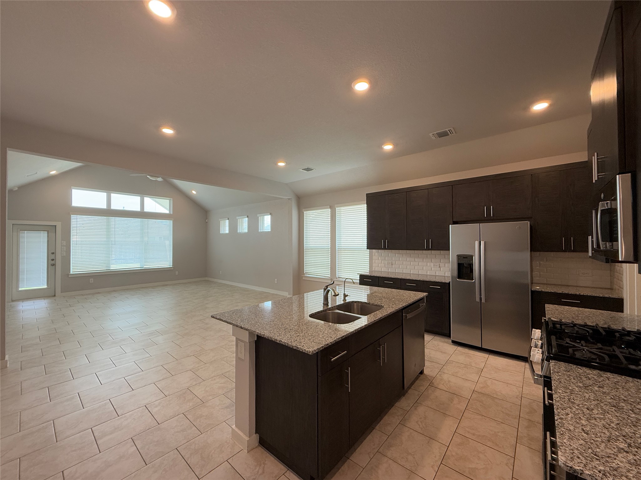 18300 Emu Lane Manor, TX 78653 - Photo 2 of 35 a kitchen with stainless steel appliances granite countertop a refrigerator and a sink