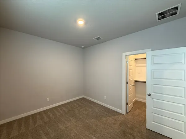 a view of an empty room and a window