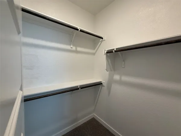 an empty room with windows and bathroom view