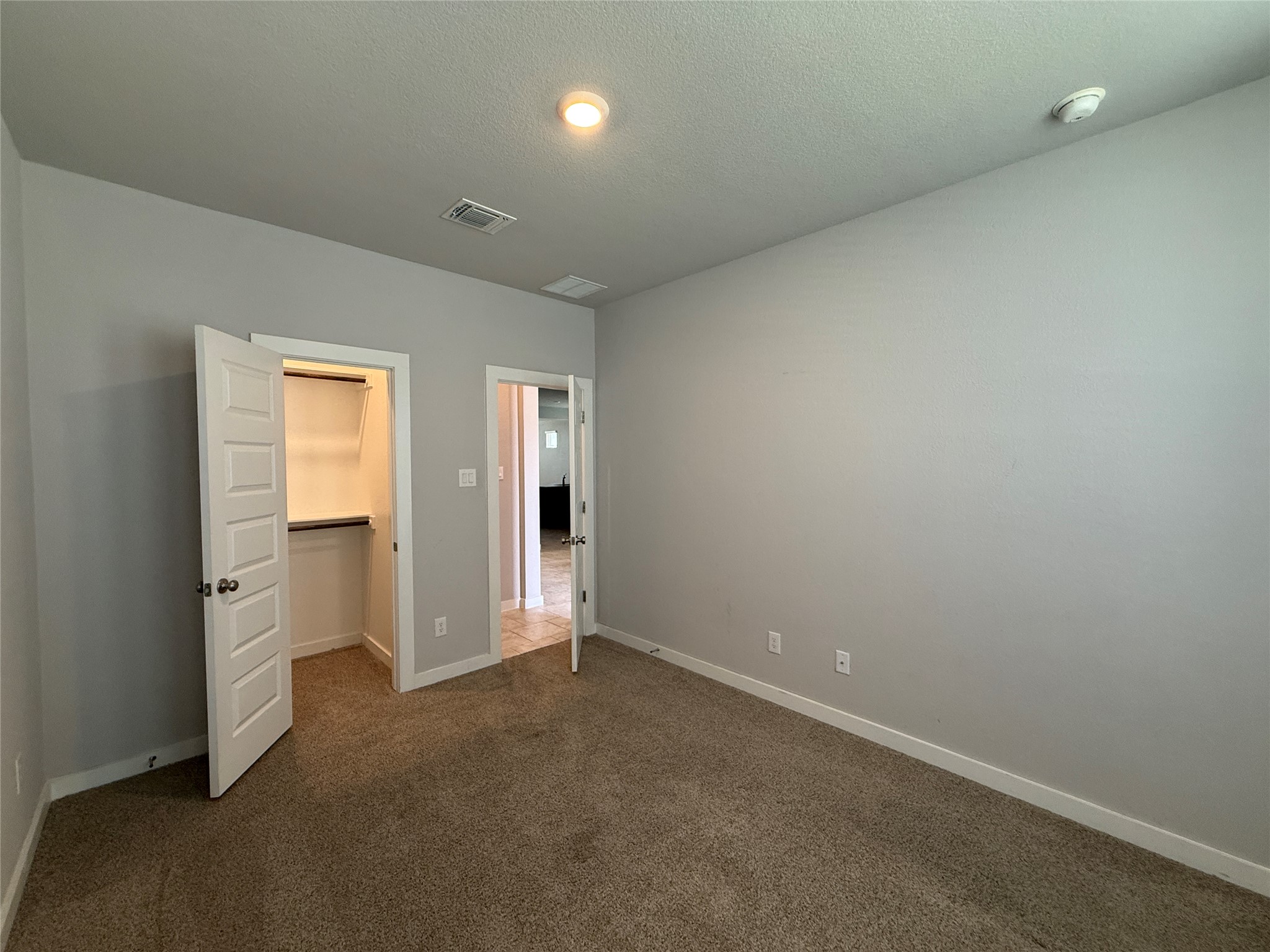 18300 Emu Lane Manor, TX 78653 - Photo 25 of 35 an empty room with windows and bathroom view