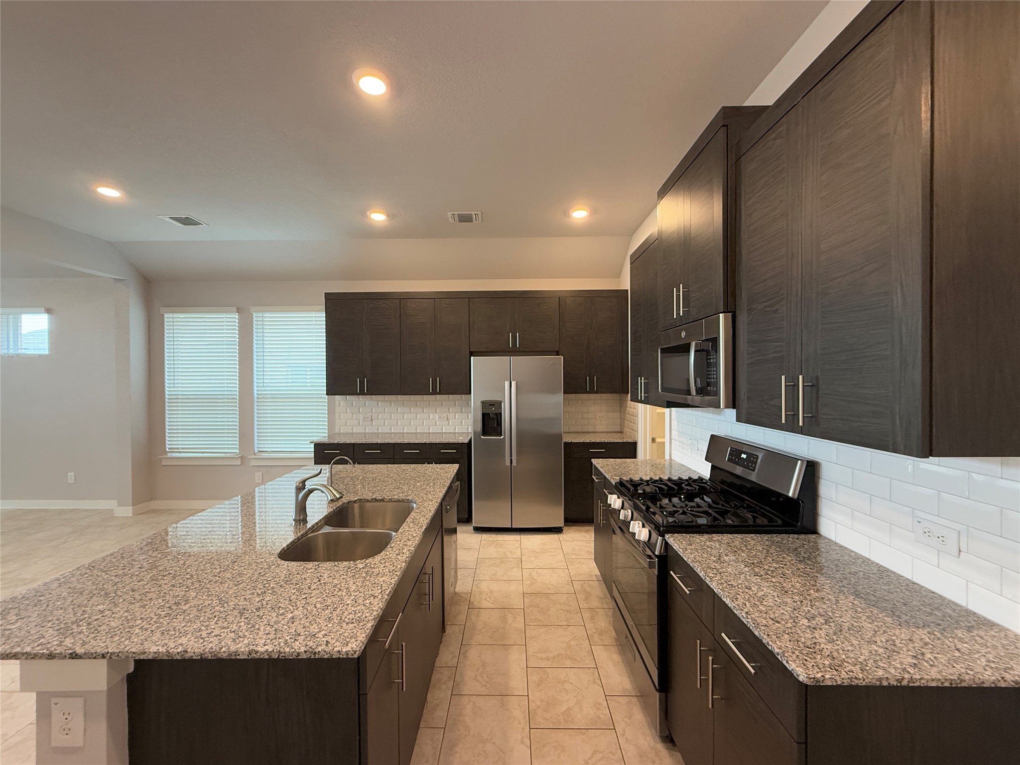18300 Emu Lane Manor, TX 78653 - Photo 3 of 35 a kitchen with stainless steel appliances granite countertop a sink and a stove