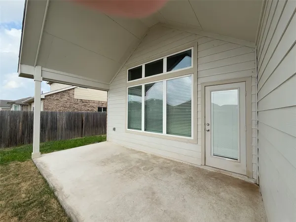 a view of a house with backyard and deck