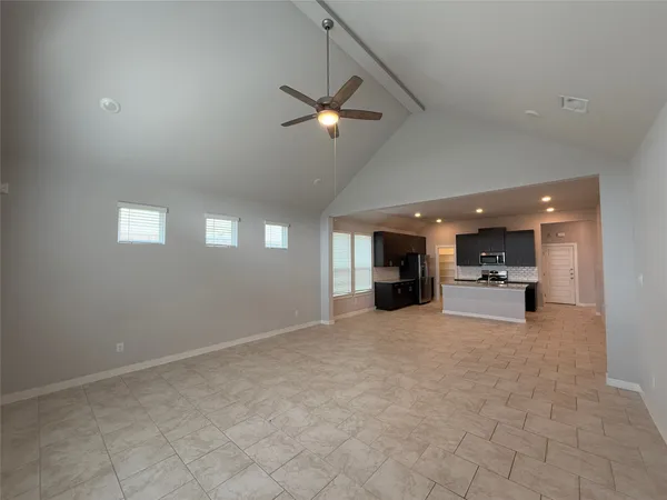 a view of a livingroom with a ceiling fan and window