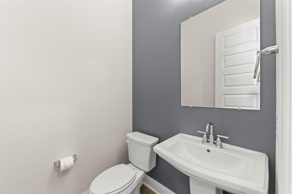 3900 Keya Drive Prosper, TX 75078 - Photo 20 of 36 a bathroom with a sink a toilet and mirror