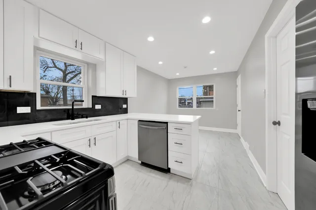 a kitchen with granite countertop a stove and a sink