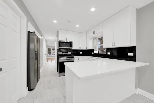 a kitchen with stainless steel appliances a refrigerator sink stove microwave and cabinets