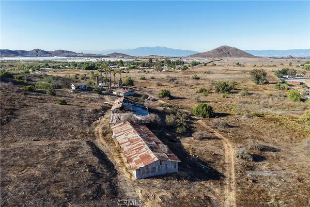 a view of a yard with wooden fence