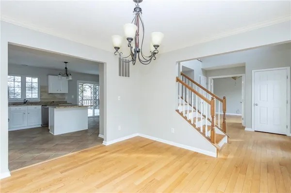 a view of entryway and hall with wooden floor