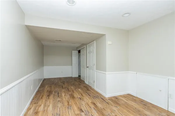 a view of empty room with wooden floor