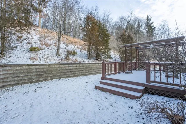 a view of a yard with wooden fence