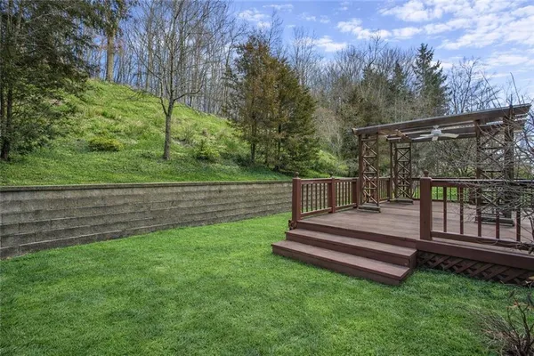 a view of a yard with wooden fence