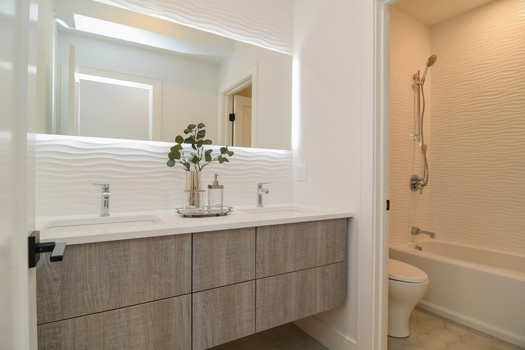 33 Cragmore Road Newton, MA 02464 - Photo 4 of 6 a bathroom with a toilet a sink and mirror