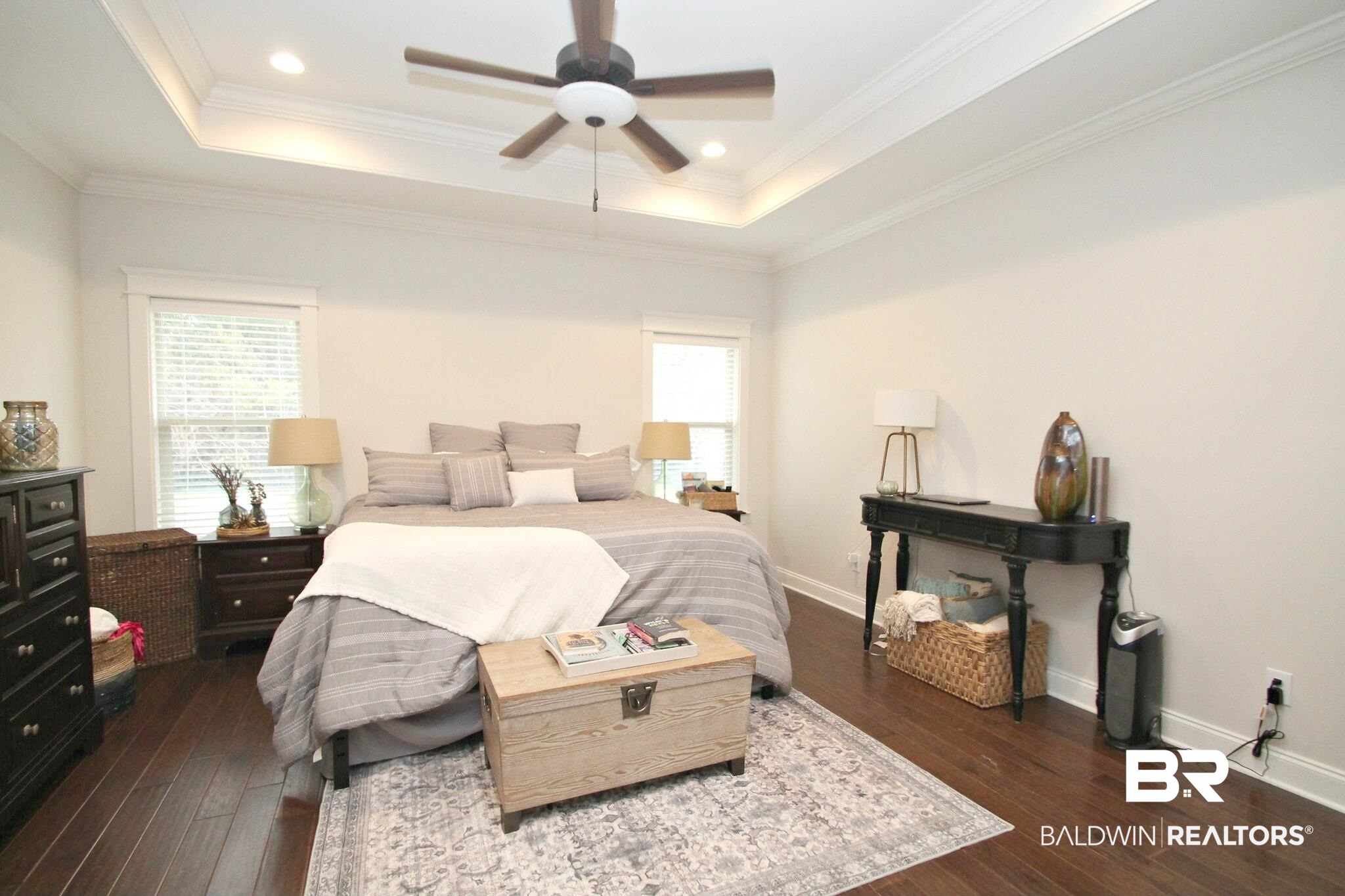 30232 Persimmon Drive Daphne, AL 36527 - Photo 11 of 27 Bedroom featuring dark wood-style floors, a tray ceiling, and multiple windows