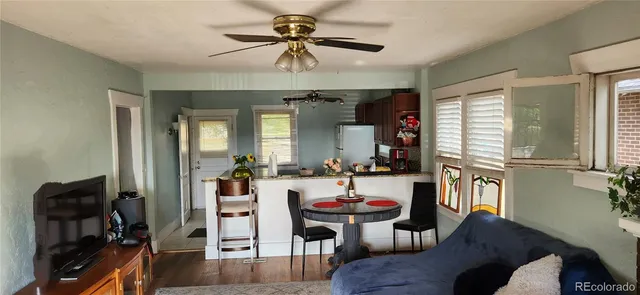 a view of a dining room with furniture and a chandelier