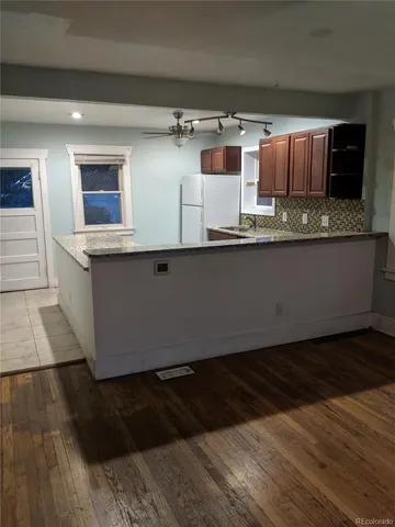 a kitchen with granite countertop a sink and cabinets