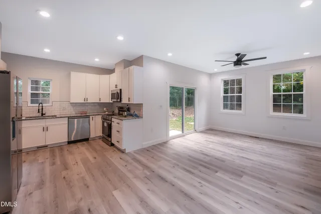 a kitchen with a sink stove and cabinets