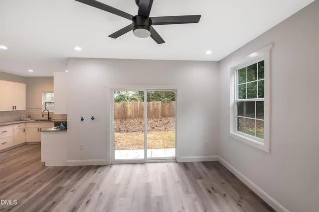 an empty room with closet and windows