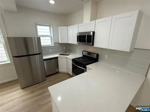 a utility room with sink dryer and washer