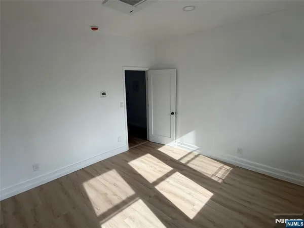 a view of an empty room and wooden floor