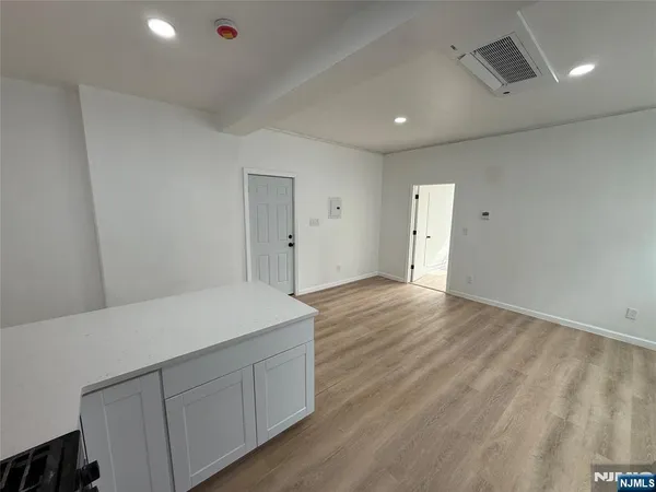 a kitchen with stainless steel appliances a refrigerator sink and microwave