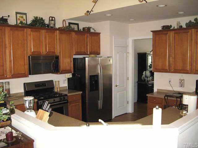7710 Elon Drive Raleigh, NC 27613 - Photo 4 of 12 Spacious kitchen with Corian counters, maple cabinets, & stainless steel appliances including gas range Other