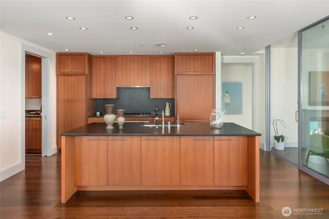 a kitchen with stainless steel appliances granite countertop a sink and a refrigerator