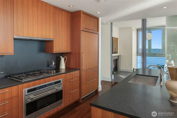 a kitchen with stainless steel appliances a stove a refrigerator and cabinets