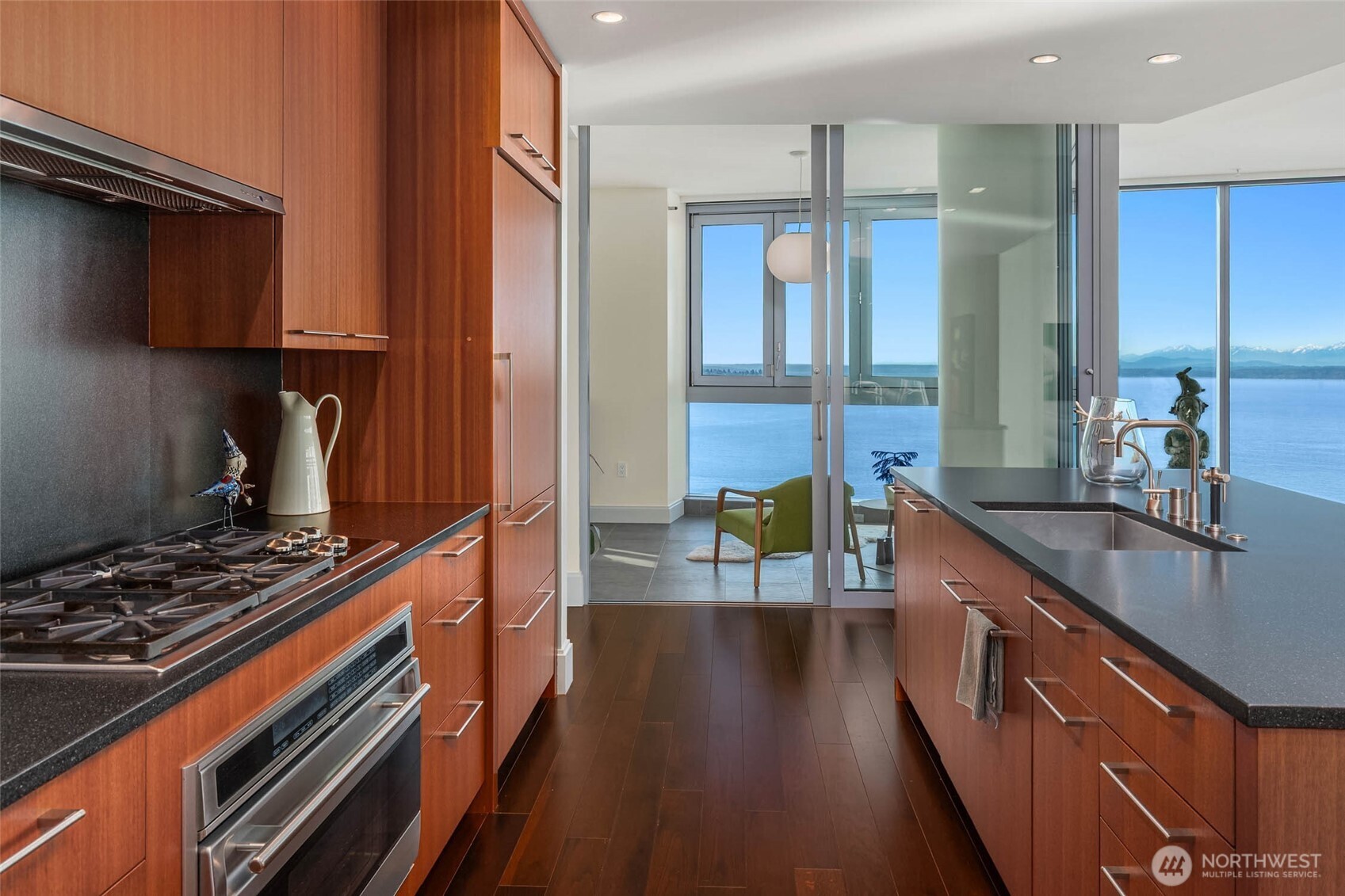 1521 2nd Avenue, Unit 3100 Seattle, WA 98101 - Photo 14 of 40 a kitchen with kitchen island granite countertop a stove and a sink