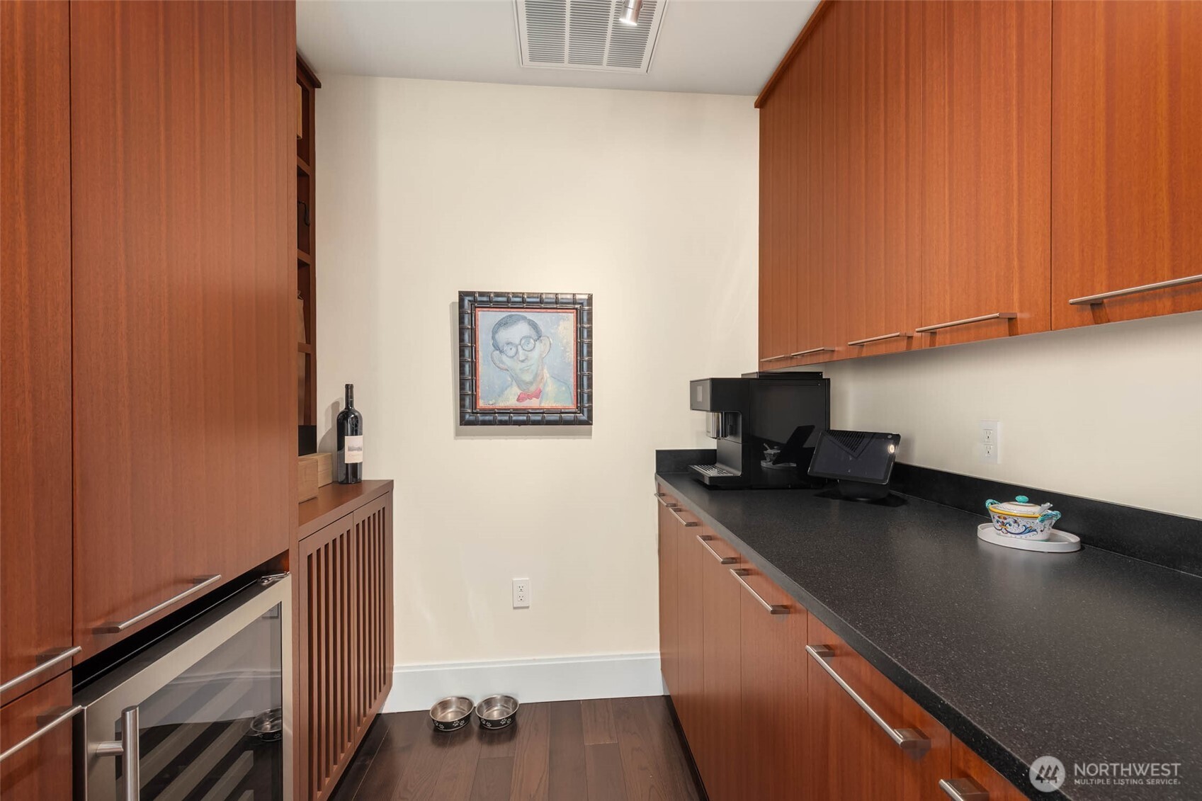 1521 2nd Avenue, Unit 3100 Seattle, WA 98101 - Photo 15 of 40 a kitchen with stainless steel appliances a sink a stove wooden floor and cabinets