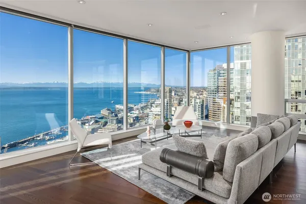 a living room with furniture and large windows