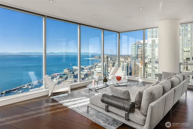 a living room with furniture and large windows