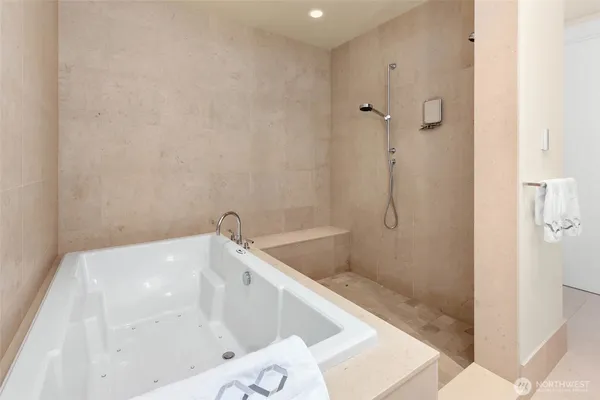 a bath tub sitting next to a shower