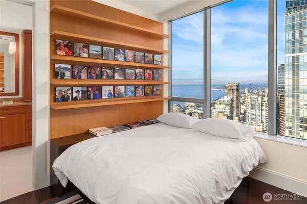 a large bed sitting in a bedroom next to a book shelf