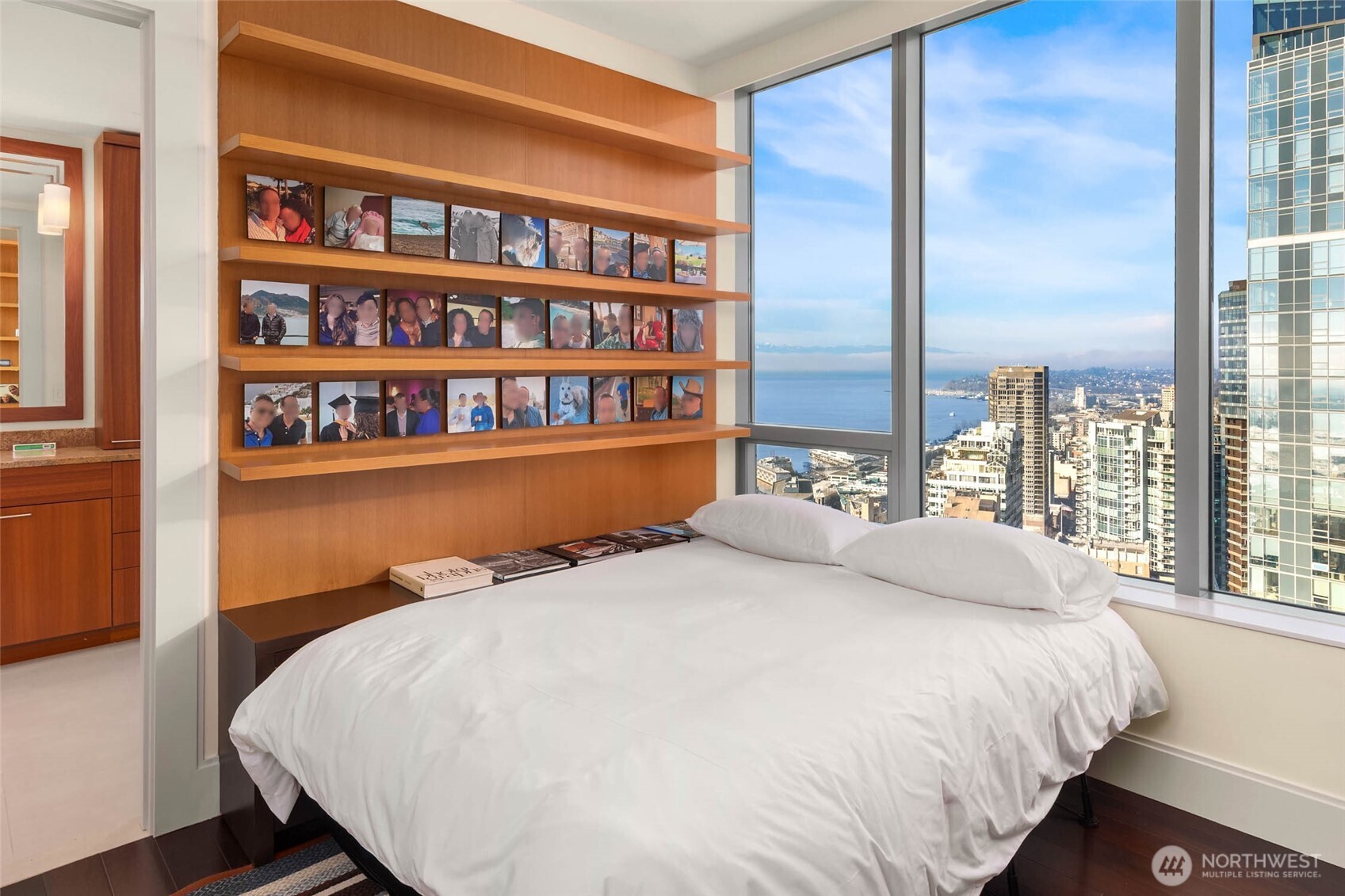 1521 2nd Avenue, Unit 3100 Seattle, WA 98101 - Photo 26 of 40 a large bed sitting in a bedroom next to a book shelf
