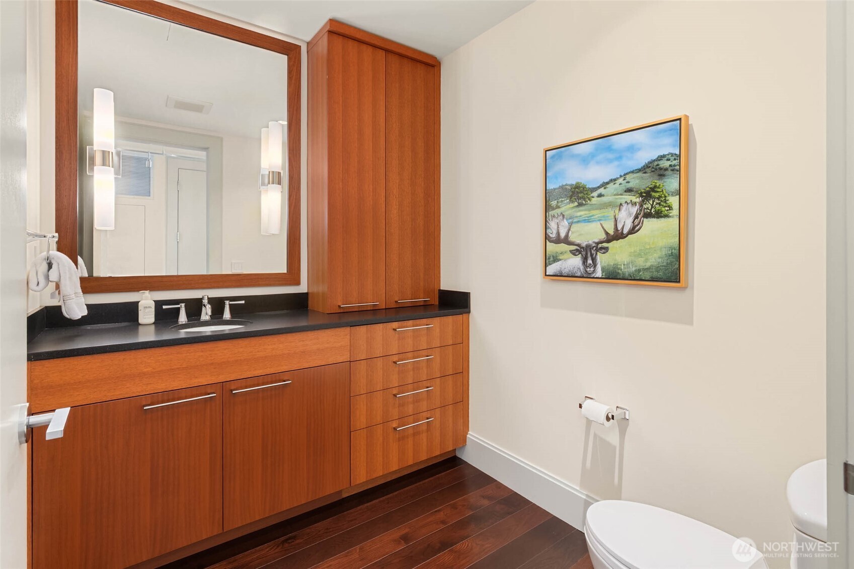 1521 2nd Avenue, Unit 3100 Seattle, WA 98101 - Photo 28 of 40 a bathroom with a toilet a sink and mirror