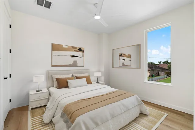 a bedroom with a bed and painting on the wall