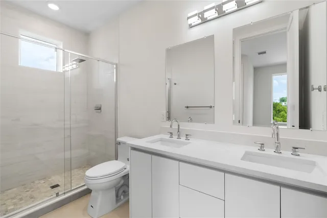 a bathroom with a sink toilet and shower