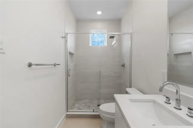 a bathroom with a sink toilet and shower