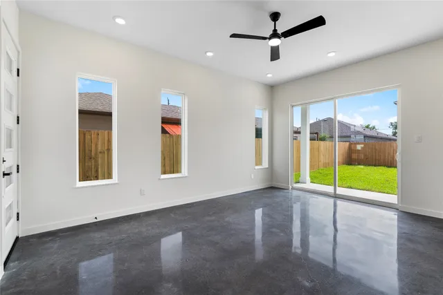 a view of a livingroom with a ceiling fan and window